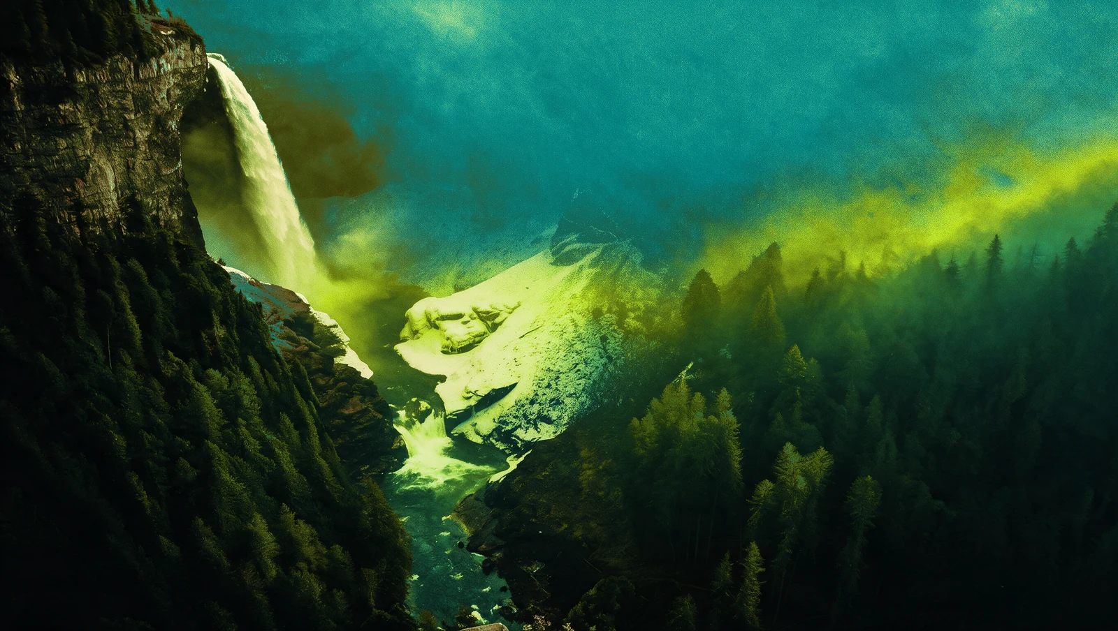 A waterfall above a forested mountain valley under a green and golden sky.